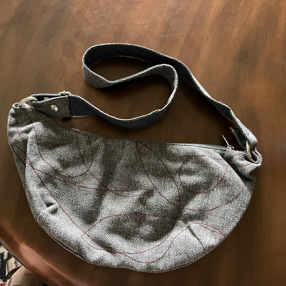 Crystalyn Kae handbag. This is a grey bag with maroon stitching.